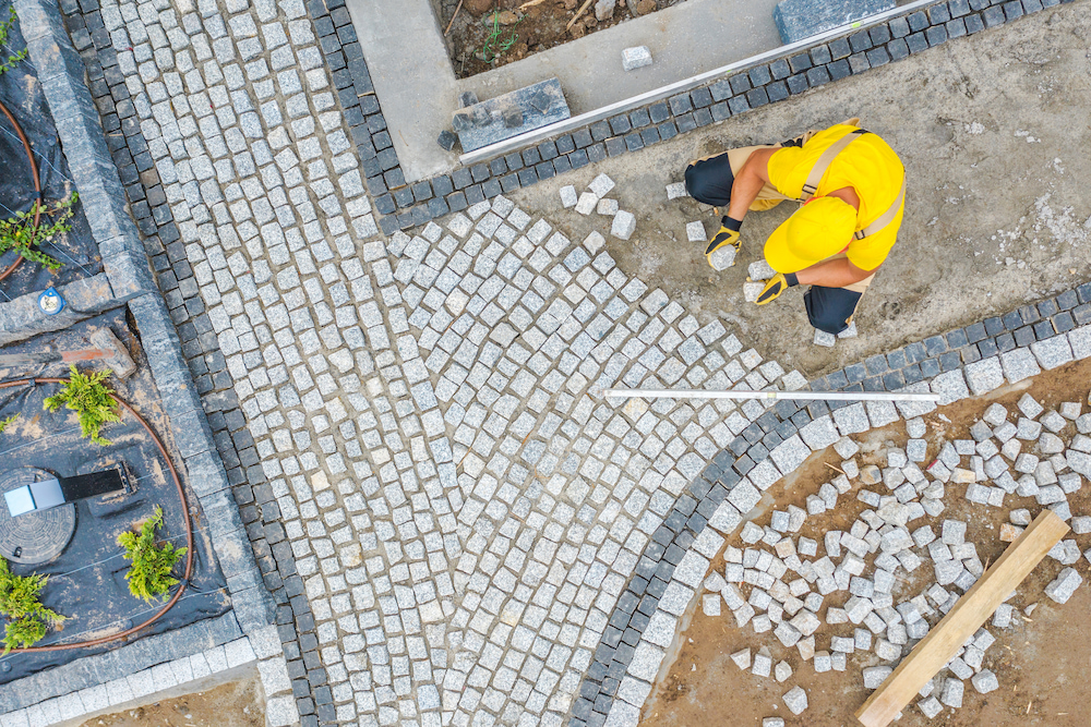 An aerial shot of a team member performing patio and paver design and installation in Prairie Village